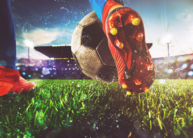 close up player kicking football