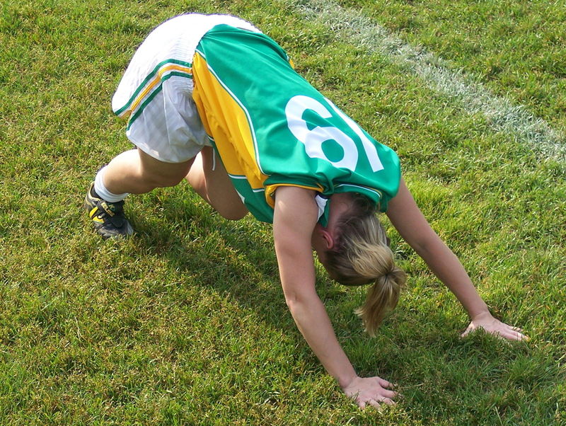 woman football stretches
