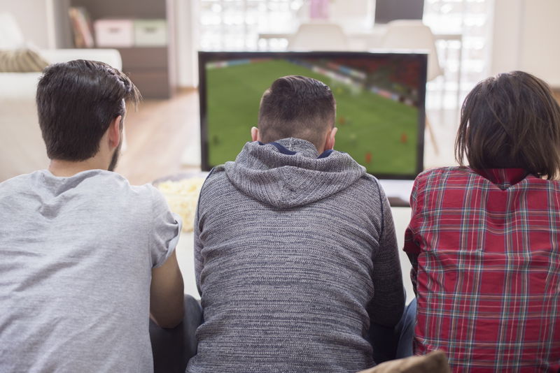 three men playing online football game
