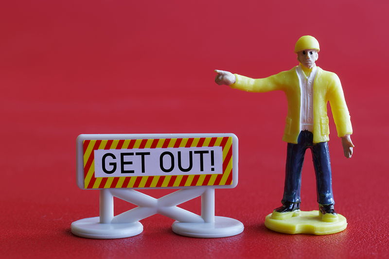 male figure points to get out sign relegated