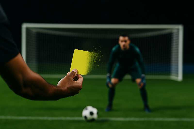yellow card being shown and then disintegrating